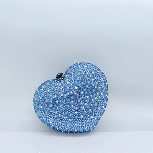 Close-up of heart-shaped evening clutch featuring sky blue rhinestones and gemstone clasp