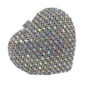 Luxurious heart-shaped evening clutch bag with iridescent rhinestones on white background
