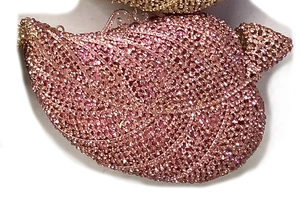 Close-up of pink leaf-shaped evening clutch featuring dense crystal rhinestone texture