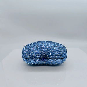 Close-up of sky blue rhinestone evening clutch bag with a deep blue crystal lock detail