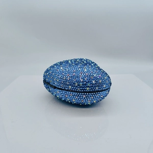 Detail of heart-shaped blue rhinestone evening clutch with sparkling crystals