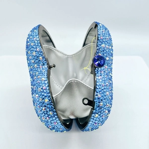 Macro detail of heart-shaped rhinestone evening bag with blue crystals and gemstone clasp