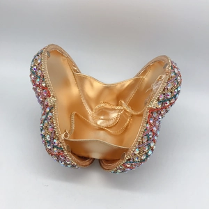 Detailed interior of heart-shaped clutch with colorful rhinestones and gold chain