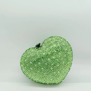 Detail of green rhinestone heart clutch bag with luxury crystal mesh and black metal clasp
