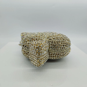 Detailed macro view of turtle-shaped evening clutch with sparkling white crystals