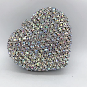 Close-up of heart-shaped clutch bag with iridescent AB rhinestones and crystal lock