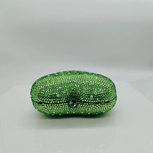 Top view of emerald green rhinestone evening clutch bag with round crystal clasp fastener
