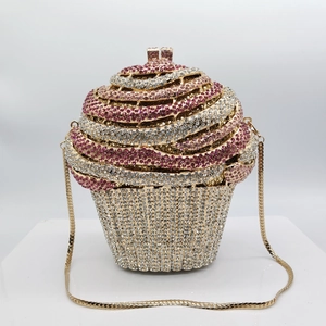 Close-up of cupcake shaped evening bag with pink and white rhinestones and gold chain