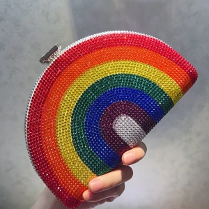 Close-up of vibrant rainbow rhinestones on a semi-circular crystal evening clutch bag