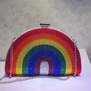 Detail of multi-colored crystals on a rainbow clutch bag with silver chain and clasp