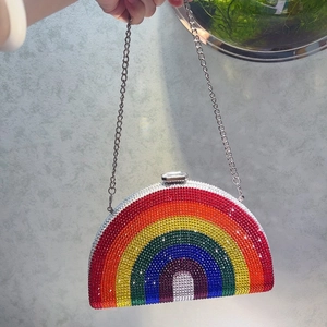 Macro detail of a rainbow rhinestone evening bag with crystals and a silver chain