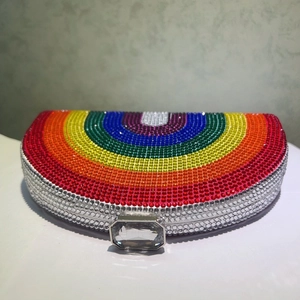 Macro shot of vibrant rainbow rhinestones and crystal clasp on the metal frame bag
