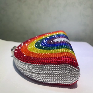 Detailed side view of rainbow rhinestone evening bag with vibrant gradient crystals
