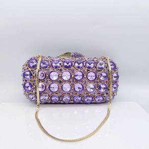 Detail view of purple rhinestone evening clutch bag with gold chain and box structure