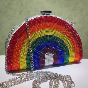 Close-up of rainbow rhinestone evening bag with crystal clasp and silver chain strap
