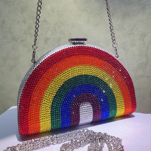 Close-up of rainbow gradient rhinestone evening bag with silver chain and crystal clasp