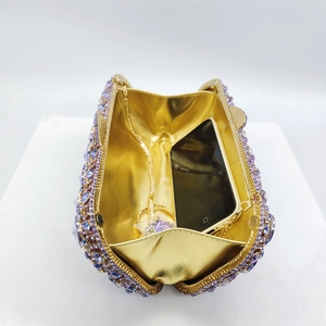 Detail of evening clutch interior with chain and phone inside gradient rhinestone bag
