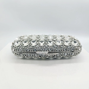 Macro detail of luxury silver rectangle evening bag with sparkling rhinestone embellishments