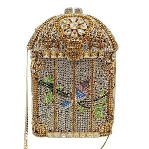 Macro detail of birdcage evening clutch with floral crystal patterns and gold chain