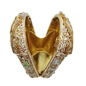 Luxurious heart-shaped gilded birdcage clutch with champagne rhinestones and chain