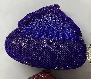 Close-up of luxury rhinestone evening bags with sparkling crystal texture and shell shape