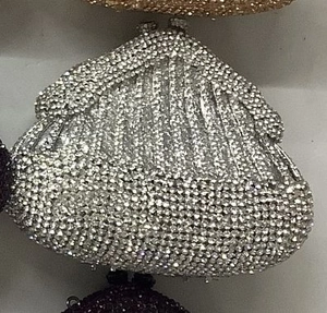 Close-up of sparkling silver rhinestone evening bag with elegant metal clasp and crystals