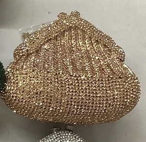 Detail of a luxury gold rhinestone evening clutch bag with sparkling diamond-set surface