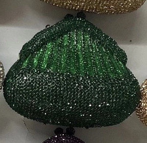 Detail of green rhinestone evening bag showing vintage metal clasp and shiny crystal texture