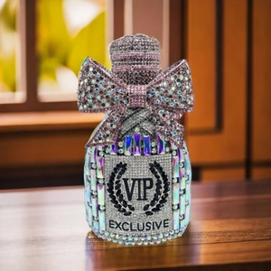 Macro detail of luxury champagne bottle evening bag with sparkling crystal bow design