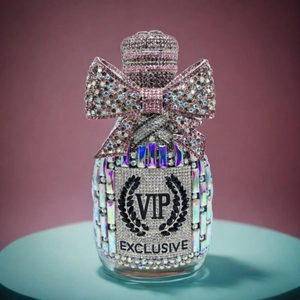 Close-up of luxury champagne bottle clutch with pink rhinestones and a VIP bow detail