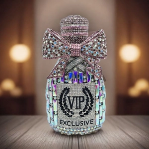 Detailed close-up of a luxury crystal champagne bottle bag with pink rhinestones and a bow