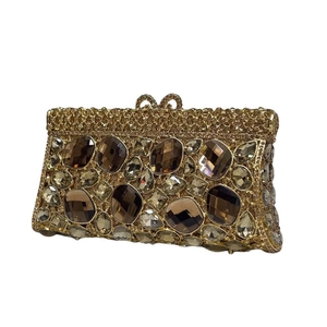 Dettaglio della lussuosa pochette dorata con gemme ambrate e decorazioni di strass brillanti