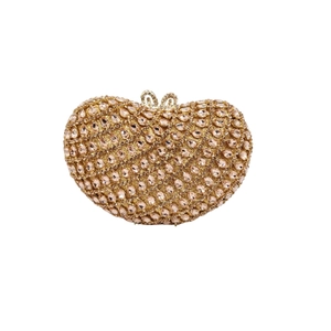 Macro view of champagne gold heart clutch with sparkling rhinestone details