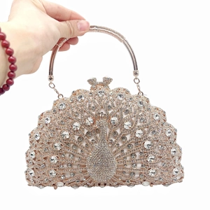 Macro shot of peacock evening clutch bag featuring intricate rhinestones and rose gold handle