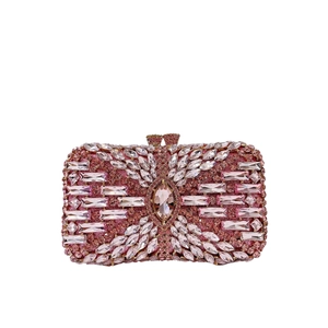 Detailed close-up of pink rhinestone evening bag with intricate crystal floral patterns