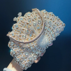 Luxurious peacock crystal evening clutch bag in champagne gold with sparkling rhinestones