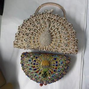 Detail of luxury peacock evening clutch bags featuring shimmering crystal-encrusted metal shells