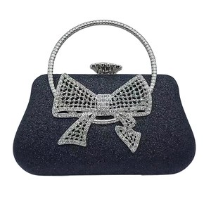 Elegant navy blue sequin evening clutch bag with a rhinestone bow and silver metal handle