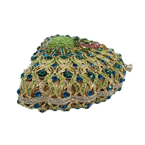 Side view of heart-shaped evening clutch bag with peacock feather rhinestones