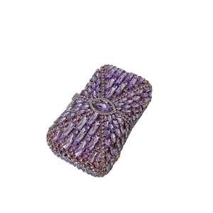 Macro detail of purple rhinestone evening clutch bag with intricate crystal flower pattern