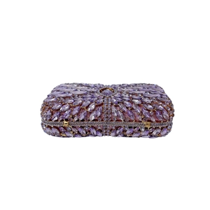 Detailed close-up of purple crystals and hollow metal frame on evening clutch bag