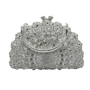 Macro shot of silver peacock evening clutch bag with crystal pavé and metal handle