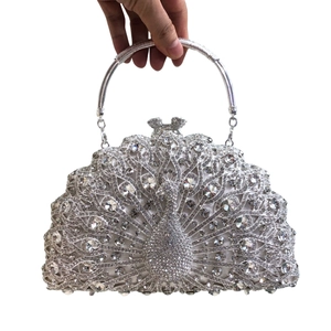 Detailed view of silver peacock evening clutch bag with sparkling rhinestone embellishment