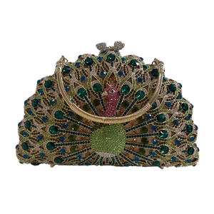 Detailed close-up of peacock-shaped clutch bag with luxury colorful crystals and gold handle