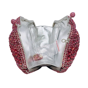 Detailed interior of a pink rhinestone owl evening clutch bag with spare crystals