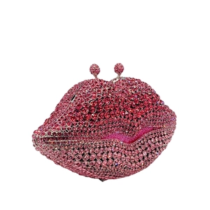 Detailed close-up of pink crystal rhinestones on a lip-shaped evening clutch bag