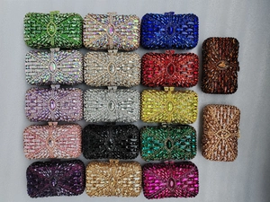 Macro view of luxury evening clutch bags with multi-color rhinestones and metal closure