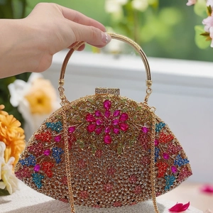 Close-up of fan-shaped clutch with multicolored rhinestones and floral crystal pattern