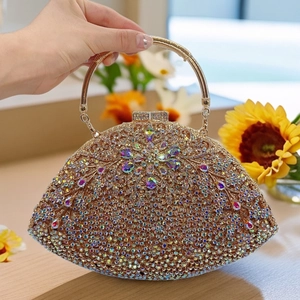 Detail of wisteria floral crystal clutch bag featuring a circular handle and rhinestone inlay