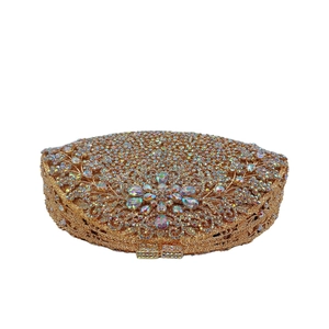Close-up of luxury gold floral clutch with crystals and rhinestones for evening gowns